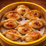 Pan-fried dumplings arranged in a circular bamboo steamer basket