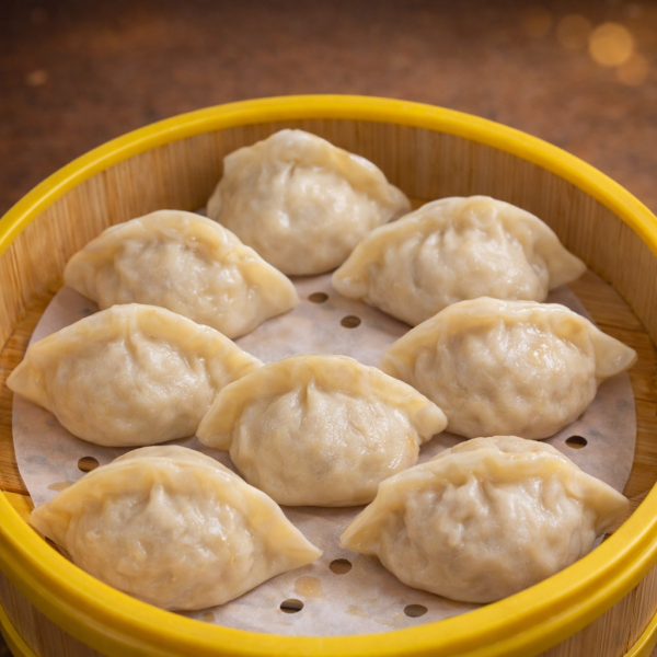 Steamed dumplings served in a bamboo steamer basket