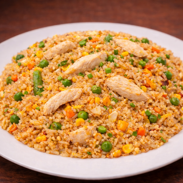 Chicken fried rice with peas and corn on a white plate