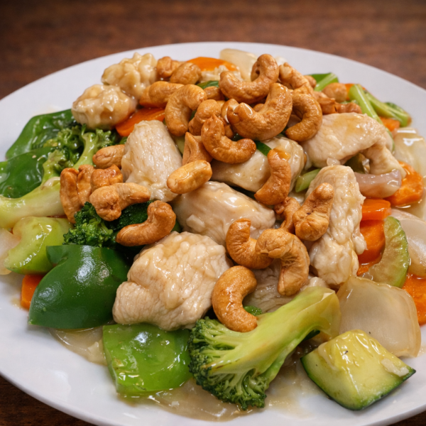 Stir-fried chicken with cashews, broccoli, carrots, and green bell peppers on a white plate