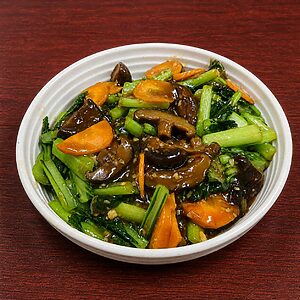 Stir-fried gai lan with sliced shiitake mushrooms and carrots in a savory brown sauce