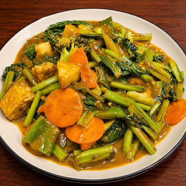 Stir-fried tofu with broccoli, carrots, and leafy greens in a savory brown sauce